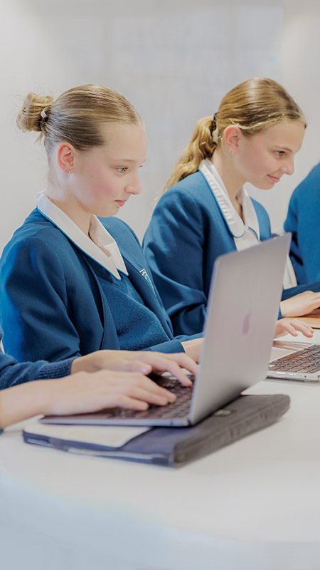 Caroline Chisholm Catholic College Glenmore Park students sitting at desk