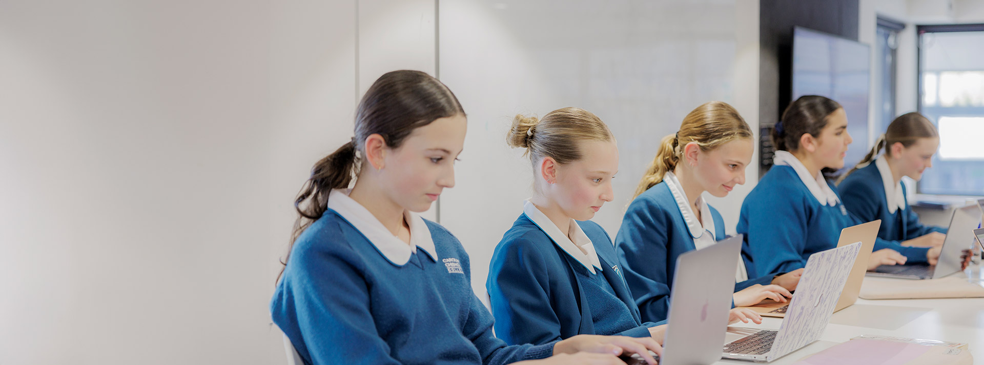 Caroline Chisholm Catholic College Glenmore Park students sitting at desk