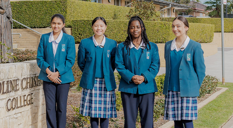 Caroline Chisholm Catholic College Glenmore Park students standing at school entrance