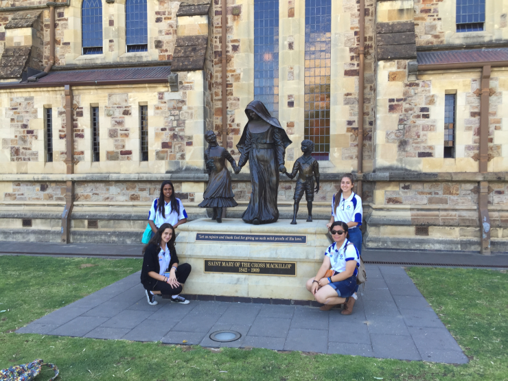 Catherine McAuley students with the Monument to St Mary MacKillop of the Cross at St Francis Xavier