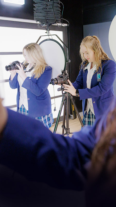 Caroline Chisholm Catholic College Glenmore Park students in photography studio using cameras