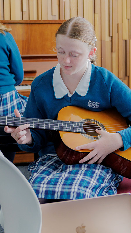 Caroline Chisholm Catholic College Glenmore Park students playing instruments in orchestra