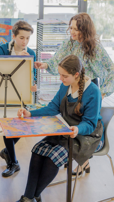 Art class at Caroline Chisholm Catholic College Glenmore Park. Students are painting on easels