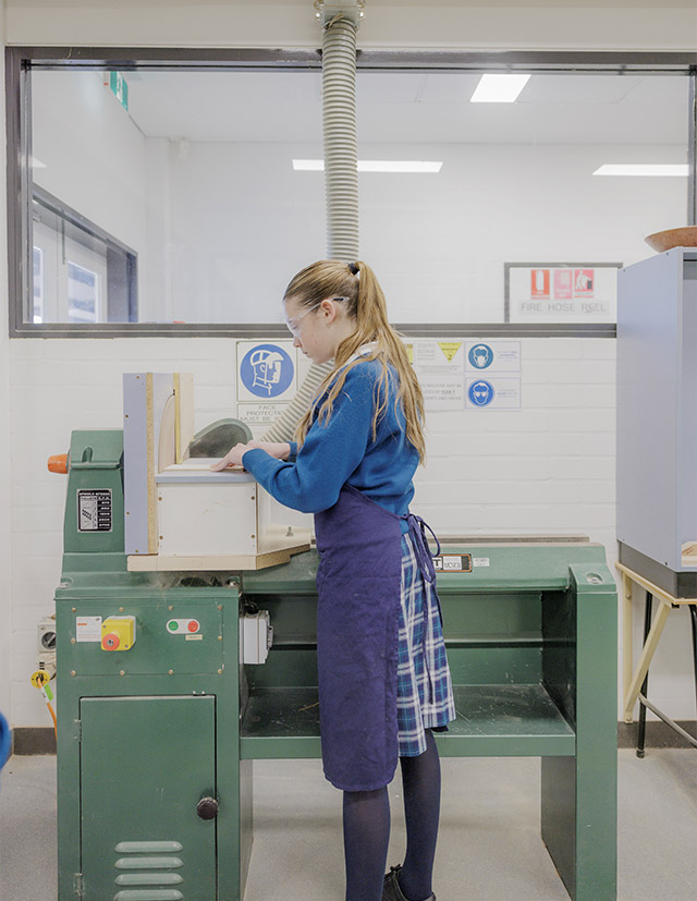 Caroline Chisholm Catholic College Glenmore Park student using woodwork tools