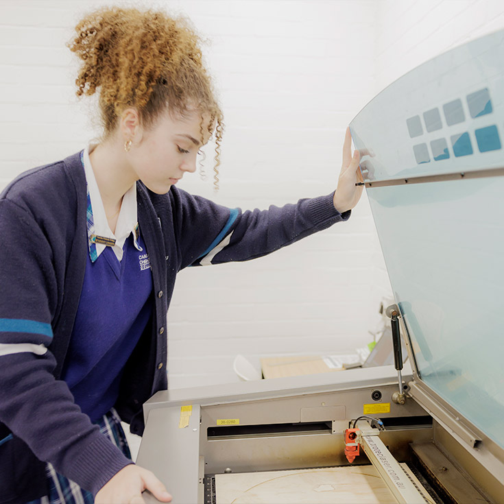 Caroline Chisholm Catholic College Glenmore Park student using wood laser cutter