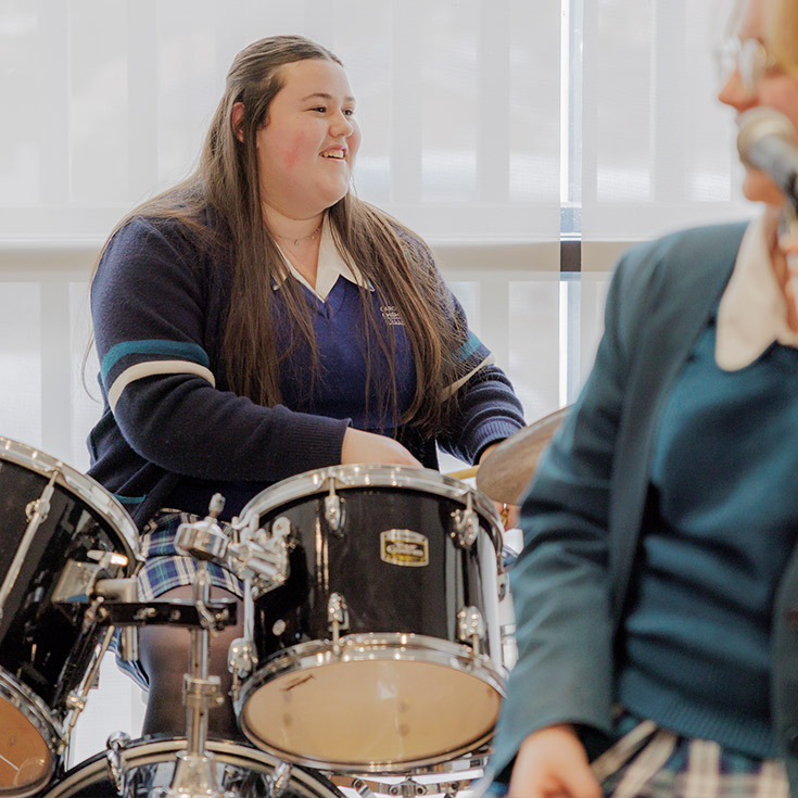 Caroline Chisholm Catholic College Glenmore Park student playing the drums