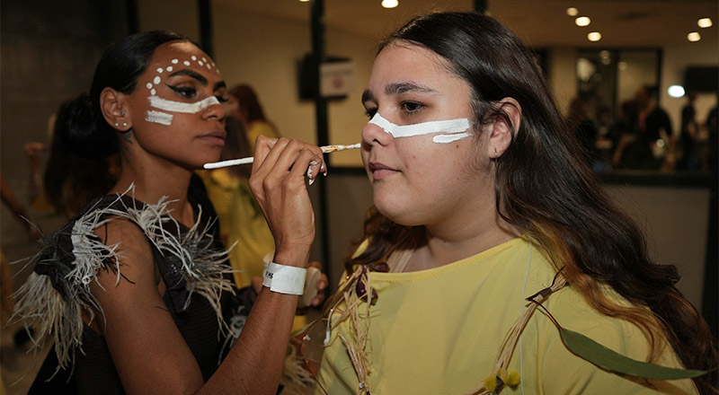Caroline Chisholm Glenmore Park student receiving Aboriginal face paint before performing the Welcome to Country for the opening game of the Matildas' campaign in the Women's World Cup